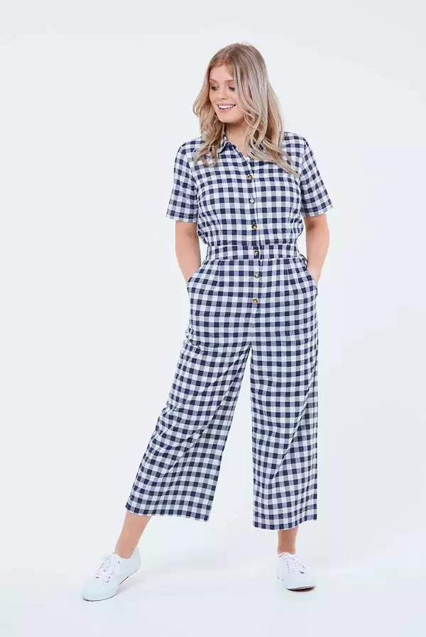 A woman wearing a check boiler suit with pockets